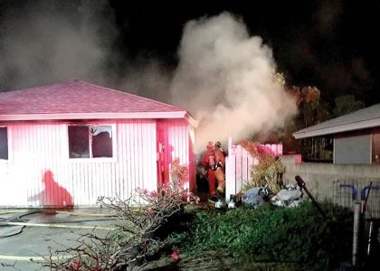 Woman helped out of burning home